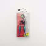 Titanum Series eyelash curler with black metal frame and iridescent mermaid-style handles in a clear plastic retail display box.